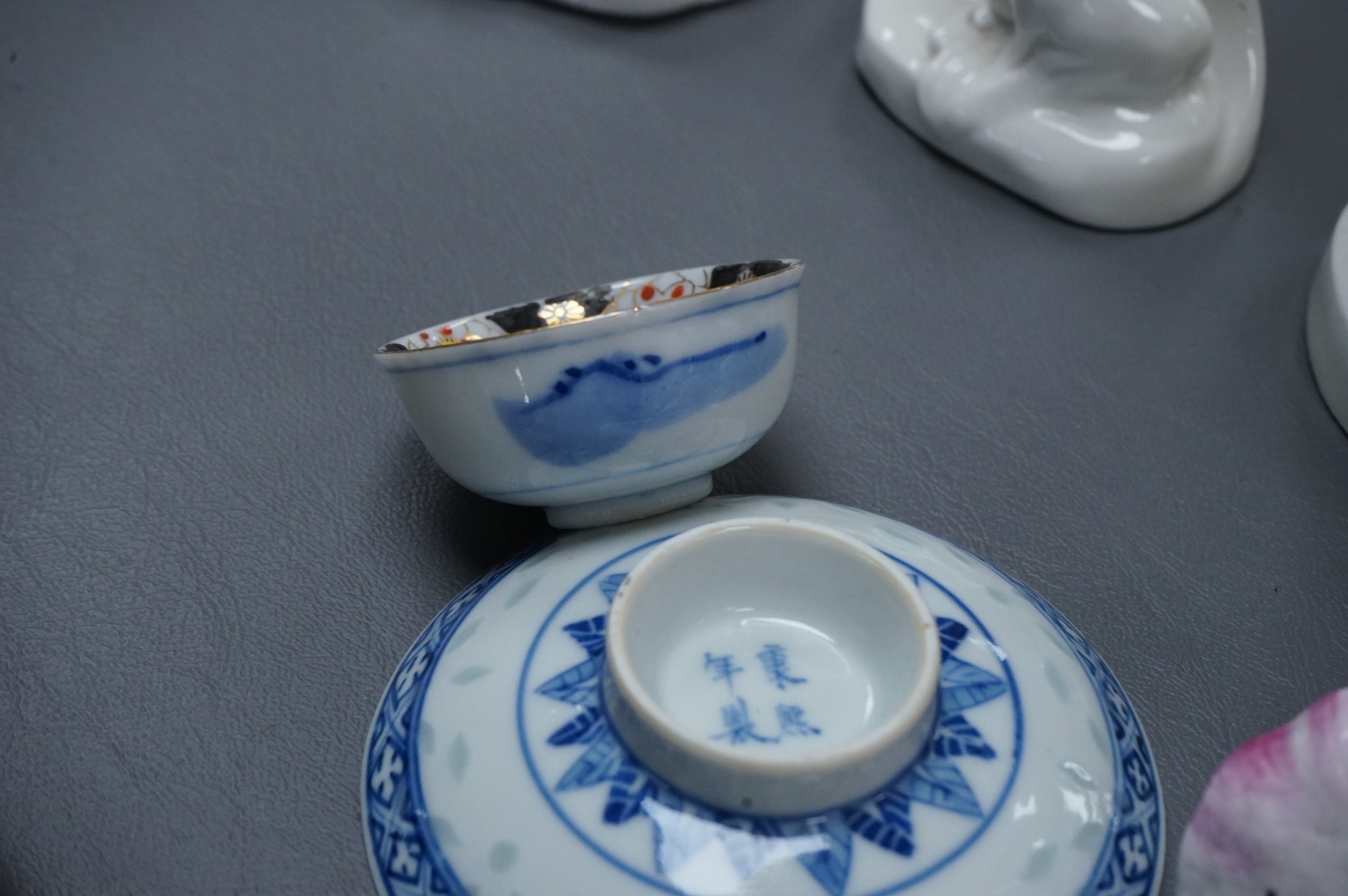 Four Chinese blanc de chine figures and two blue and white dishes and a model of a garlic bulb. Tallest figure 17.5cm.